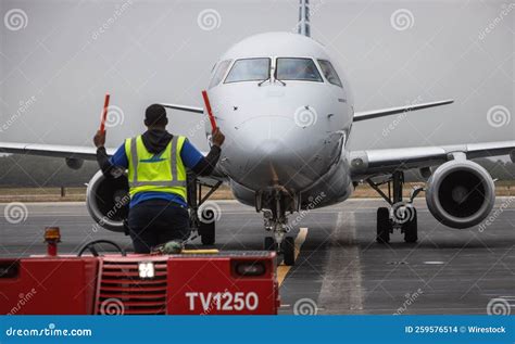 Man Guiding an American Airlines Plane into Its Parking Spot at the ...