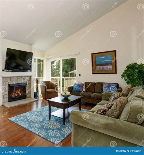 Excellent Living Room with Blue Rug and Fireplace. Stock Photo - Image ...