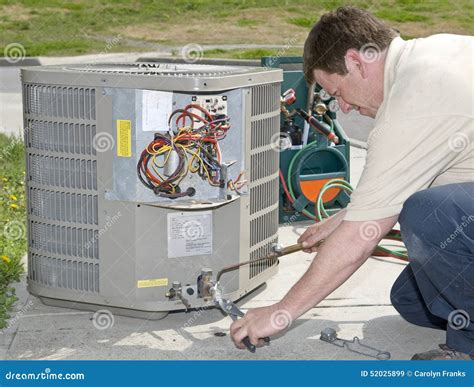 AC Repairman Welds Connector on Replacement Air Conditioning Unit Stock ...