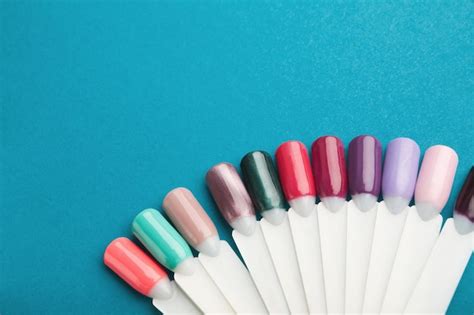 Nail lacquer color swatches pallete on blue background, copy space ...