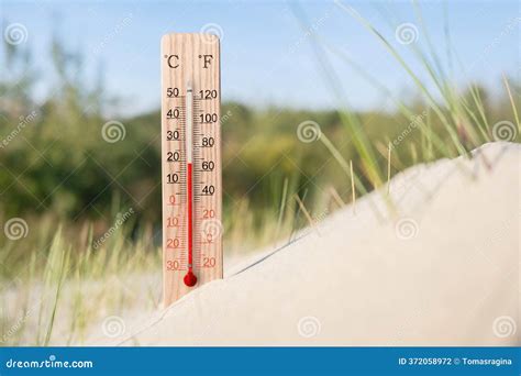 Wooden Celsius And Fahrenheit Scale Thermometer In The Sand. Ambient ...