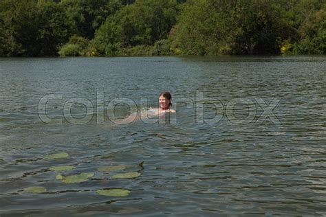 Woman swimming in river | Stock image | Colourbox