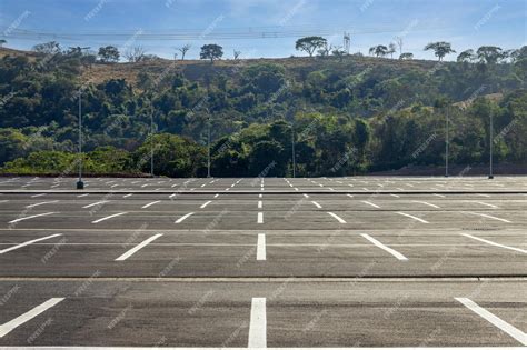 Premium Photo | Big parking lot completely empty with hill covered by ...
