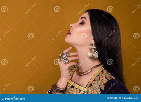 Photo of Elegant Stunning Lady Arabian Queen in National Clothes Touch Neck Over Pastel ...
