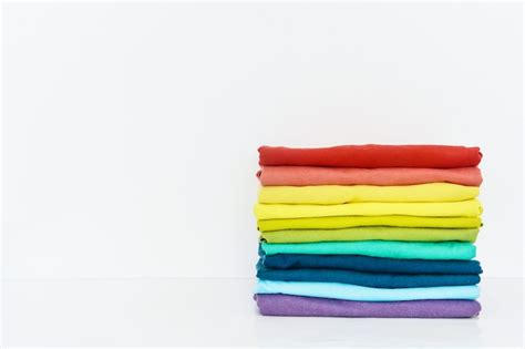 Stack of colorful t-shirt on white background | Premium Photo