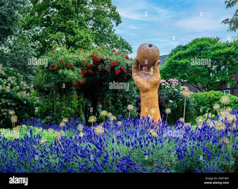 Wyndham Park, Grantham, Lincolnshire, UK. A wood hard carved sculpture called Isaac’s Apple ...