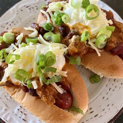 A bowl of Laura's quick slow cooker turkey chili, topped with shredded cheese, sliced green onions,