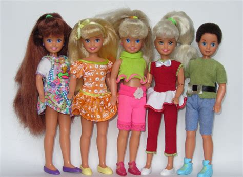 five dolls standing next to each other in front of a white background