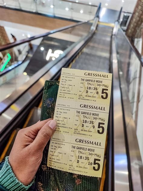 hand holding a cinema ticket for Cinema XXI or Cinema 21 which is ...