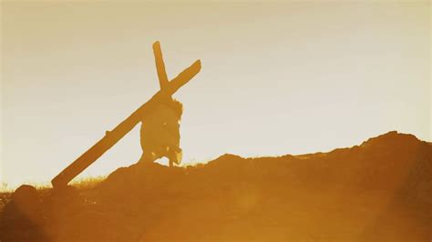 Christ silhouette carrying a heavy Cross - Long Shot Stock Video Footage 00:10 SBV-338662020 ...