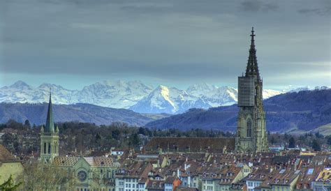 Bern, capital city of Switzerland - View of Bern with the cathedral and the Bernese Alps in the ...