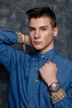 Man in denim shirt, arms on hips, gray background. people lifestyle ...
