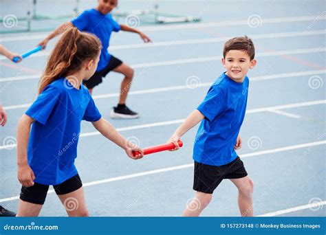 Children in Athletics Team Competing in Relay Race on Sports Day Stock Photo - Image of group ...