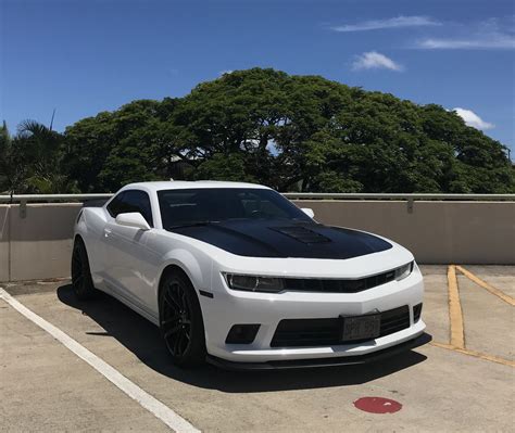 White Chevrolet Camaro Parked in a Parking Lot