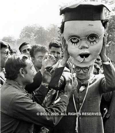 Prime Minister Vishwanath Pratap Singh trying on a mask to be used for ...