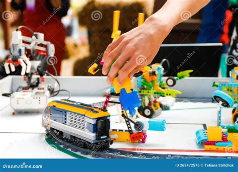 Defocus Children Hands Holding Ready Made Robots on Table. Train an ...