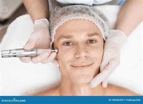 A Man Came To Laser Hair Removal Facial. Doctor Leads Him in the Face with a Modern Laser ...