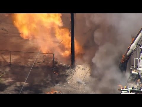 Major gas line breaks, causing huge flames to erupt from the ground.