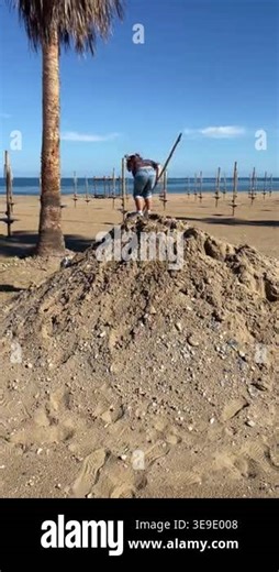 A little girl plays on top of a massive sand mound on a deserted beach during the off-season. The footage captures a peaceful, melancholic atmosphere by the gray sea. High quality 4k footage Stock Video Footage - Alamy