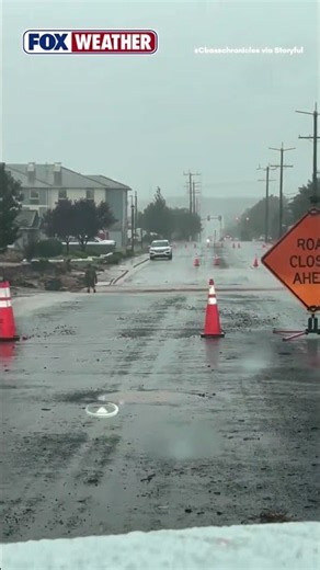 Floodwaters rush over Utah road