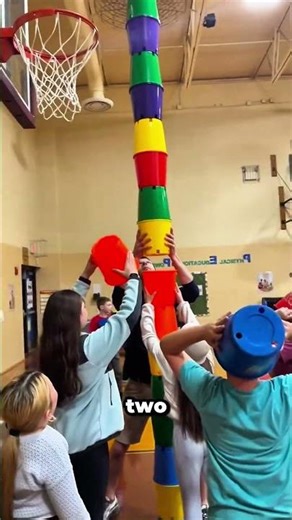 This cup stacking trick requires perfect balance and teamwork