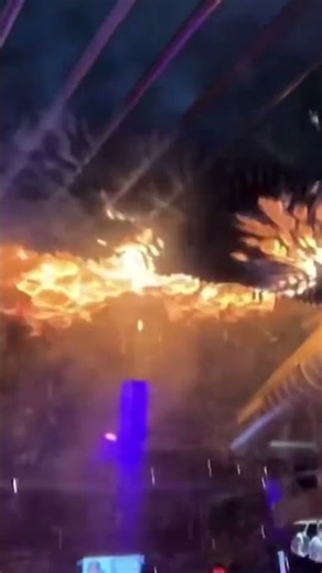 Revellers keep filming as ceiling catches fire