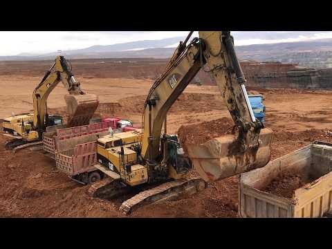 Two Caterpillar 365C Excavators Loading Mercedes And MAN Trucks