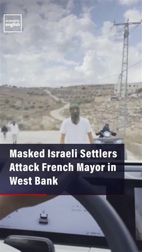 Eyewitness footage shows Bernard Baudoux, Mayor of France’s Aulnoye-Aymeries, sitting on the ground after a settler attack in the occupied West Bank, as masked settlers confront activists and surround their vehicle.