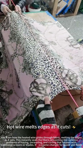 A worker cuts fabric with a hot wire cutter! 👨‍🏭