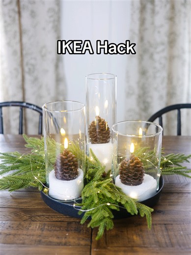 You'd never guess this cozy Christmas centerpiece started with $15IKEA hurricane vases! I turned this simple IKEA find into a beautiful, high-end looking Christmas centerpiece using Epsom salt, the cutest pinecone flameless candles from Amazon, faux greenery, and a little sparkle from twinkle lights! It's such an easy way to get that cozy, designer Christmas look without spending a fortune. And I LOVE how magical it looks all lit up! SAVE this idea for your Christmas decorating! ❤️ #IKEAHack #IK