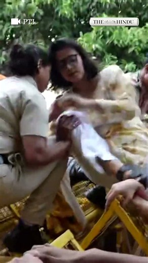 AISA chief Neha Bora climbs barricade during protest against CEC Gyanesh Kumar