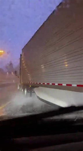 Semi Jackknifes Across Highway as Lightning Rips Through Severe Storm Great Plains, U.S. — A violent storm turned a routine highway drive into a near-disaster when a semi truck lost control and jackknifed across multiple lanes, blocking traffic as lightning cracked overhead. Dashcam footage shows torrential rain hammering the roadway as visibility drops to near zero. A sudden flash of lightning illuminates the sky just as the tractor-trailer begins to slide, its trailer swinging wide and snappin