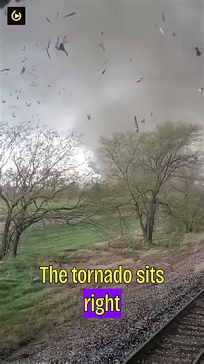 He kept filming as a tornado hit his train head-on.