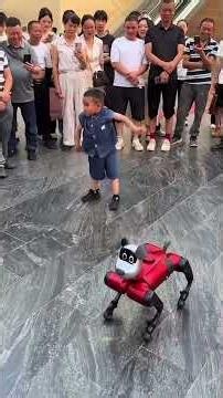 Little boy dancing with a cute robot