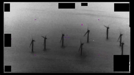 More UFO footage of a white orb flying between wind turbines.