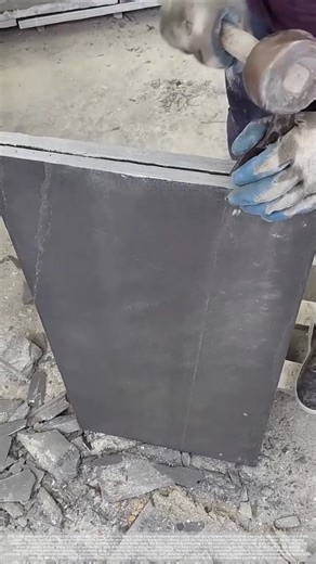 The stonemason's skill in splitting slate with a hand hammer.