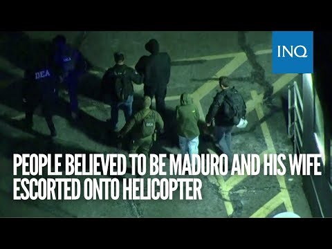 People believed to be Maduro and his wife escorted onto helicopter
