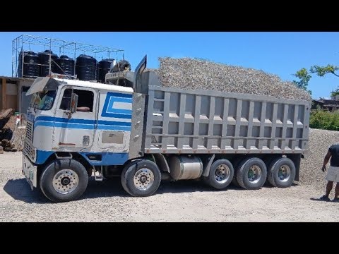 Sadeki bad international cabover offloading over 40 Tons of Gravel 