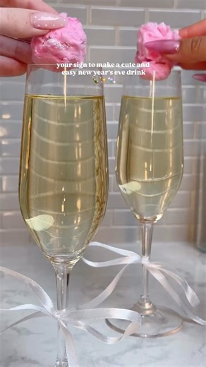 ChampagneAng | Ang Sturino on Instagram: "🥂✨ NYE Recipe Countdown: 1 Day! ✨🥂 This Glitter Bomb Prosecco is the easiest way to make your New Year’s pour feel extra. A simple drop-in sparkle that melts right into the glass — zero prep, all the fun. ✨ NYE Glitter Bomb Prosecco (Makes 2): ✨ Place ½ cup cotton candy on a plate and sprinkle with ½ tsp edible glitter. ✨ Gently roll it into 2 small balls, tucking the glitter inside as you go. ✨ Pour 3–4 oz chilled prosecco into each champagne flute (f