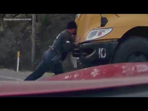 School resource officer pushes broken down bus out of traffic and into safety