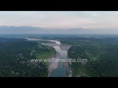 Shella Hanging Bridge in Meghalaya wide drone shot of River, Village & Green Mountains