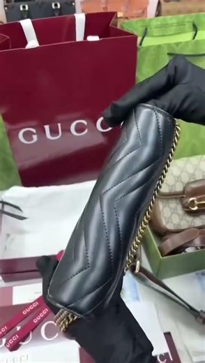 Gucci GG Marmont wallet on chain in black leather.