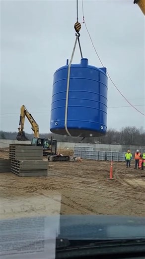 Crane Lift Ends in Watery Crash Joliet, Illinois — March 5, 2025 A seemingly routine crane lift at an industrial site turned into a costly disaster Tuesday when a massive water tank slipped from its rigging and crashed to the ground, spilling thousands of gallons of water. The dramatic video shows the large, blue tank being carefully lowered when a worker notices a critical problem, yelling, "Strap's sliding! Bring it down slow!" But the warning comes too late. The lifting strap slips off the sm