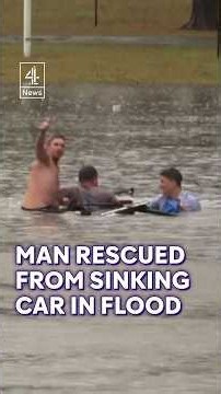 Moment driver rescued from a sinking car in Australian flood