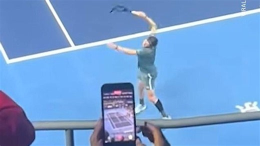 Angry tennis player smashes his racket