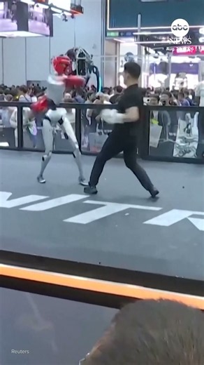 Man spars robot boxer at Chinese tech conference