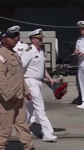 U.S. sailors embrace family members after service aboard USS Lincoln