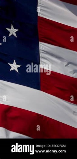Vertical 4K slow motion American flag waving in the wind gracefully in close-up with bold red, white, & blue detail. Ideal for themes of patriotism, freedom, national pride, remembrance, government, military, holidays, and American identity Stock Video Footage - Alamy