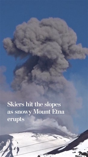 Mount Etna is a popular tourist destination all year, with its snowy landscape and frequent volcanic activity attracting people despite frequent eruptions and lava flows. Footage showed dozens of skiers continuing to summit Etna on Sunday as smoke rose in the background. https://wapo.st/4qnhuWC | Washington Post