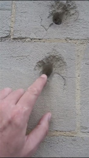 Bullet ridden wall from a blast of German machine gun fire in Paris - WWII - 1944
